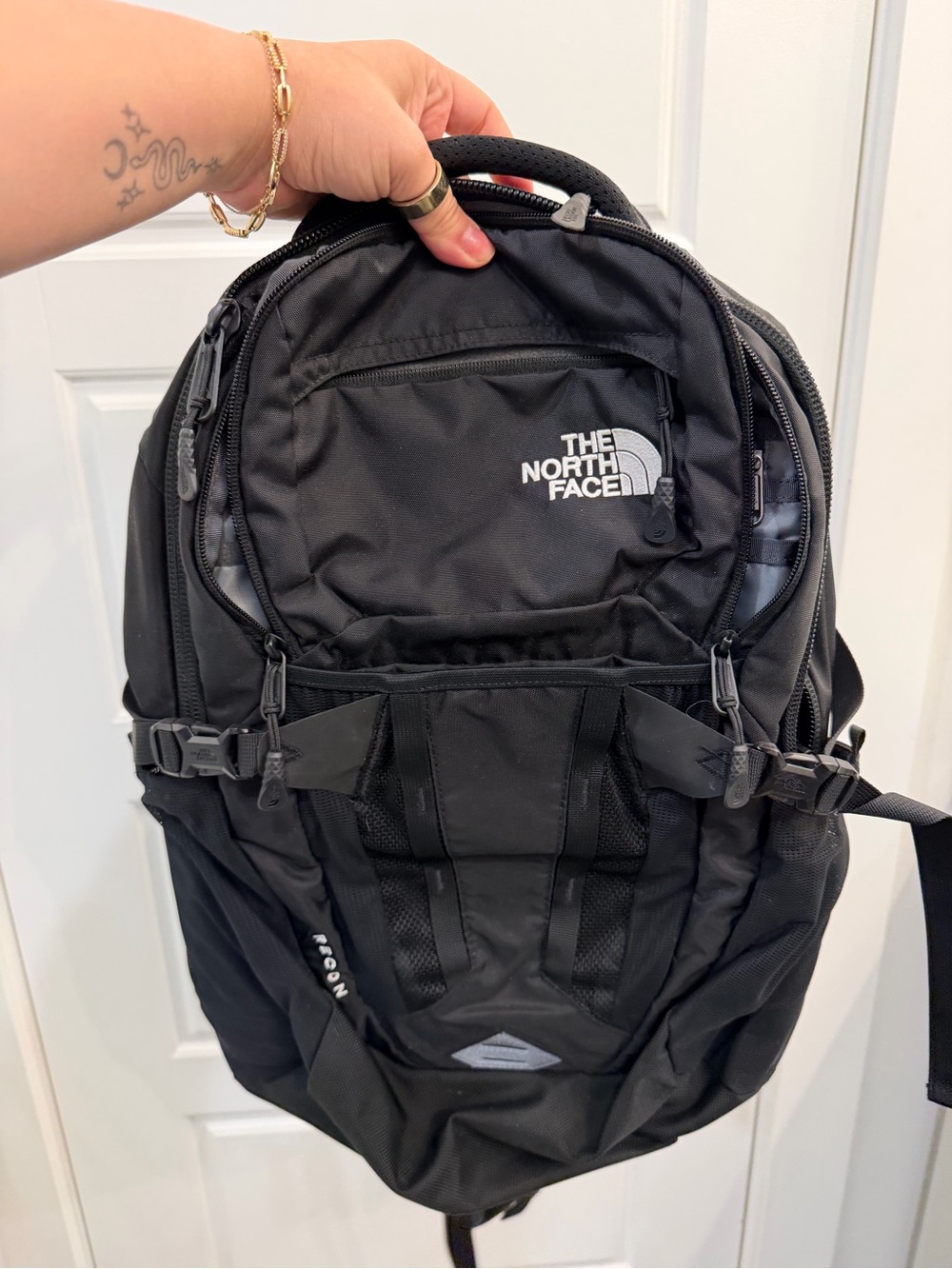 The North Face Black Backpack with Front Pocket and Buckle Straps